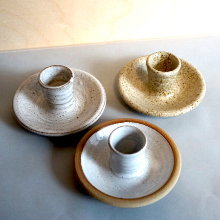 three handmade ceramic candlestick holders in three different glazes. 