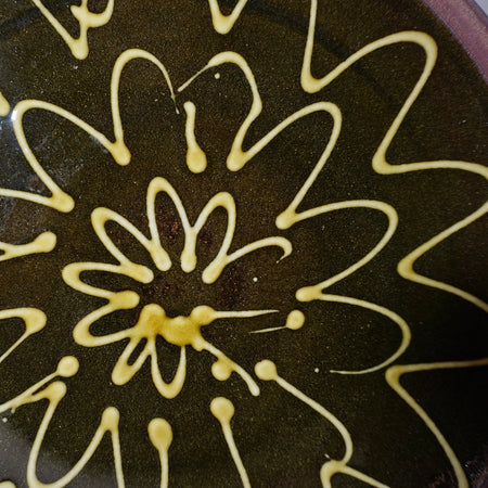 close up detail of a porcelain slip pattern on a handmade plate by lily Pearmain ceramics. 