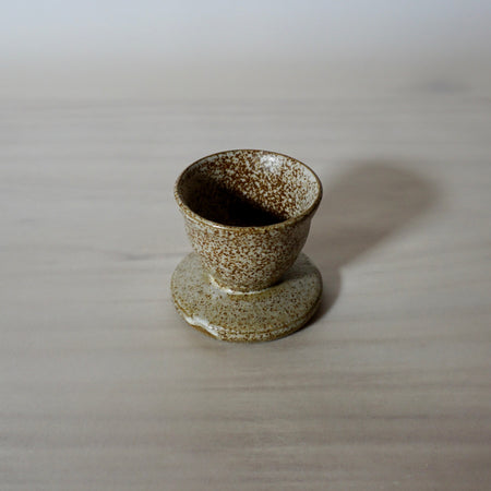 Handmade egg cup with a speckled glaze. 