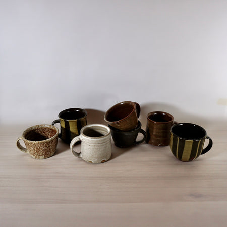 a group of handmade mugs in different sizes and shapes by Lily Pearmain Ceramics. 