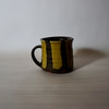 hand thrown mug by lily Pearmain ceramics in a nicotine green striped glaze. 