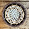 a stack of three plates on a wooden table taken from above. 