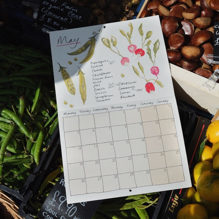 the page for May in a 2025 seasonal eating calendar with nice illustrations of radishes and peas. 