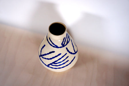  porcelain vase with a hand painted blue pattern.  