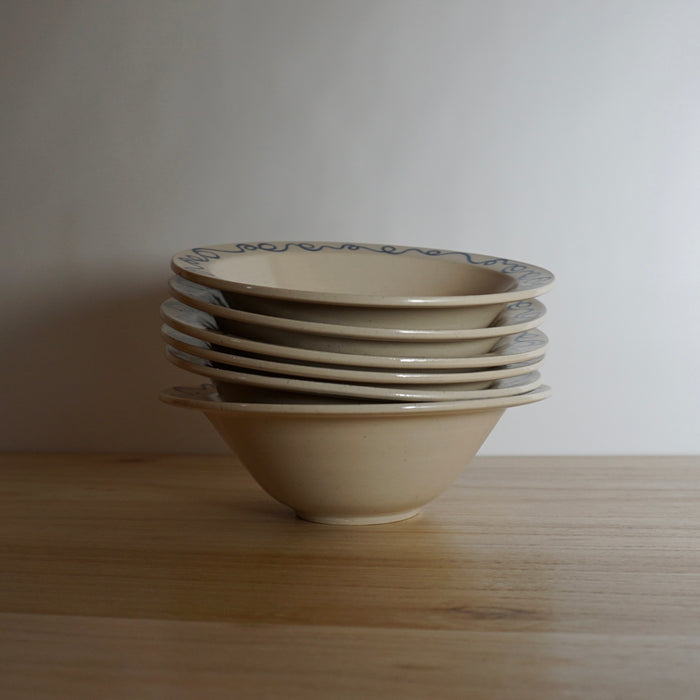 stack of pasta bowls on a table. 