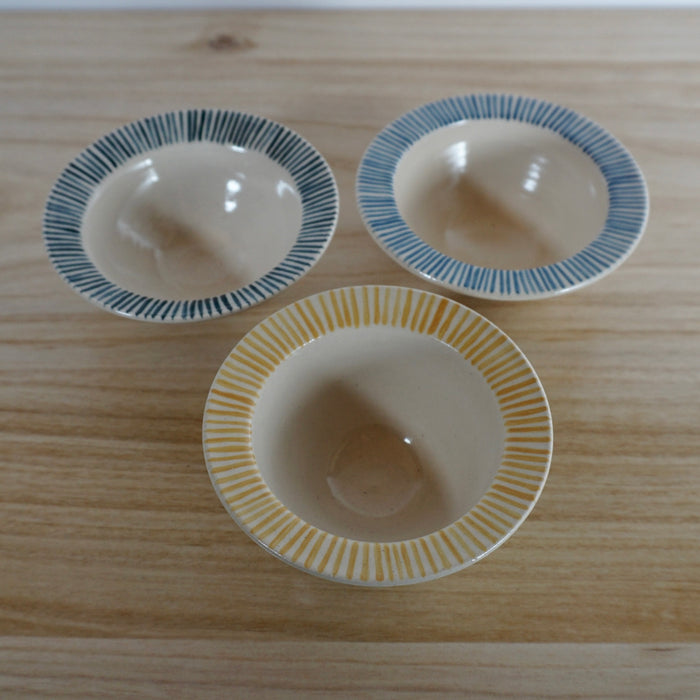 three stripped handmade ceramic snack bowls. 