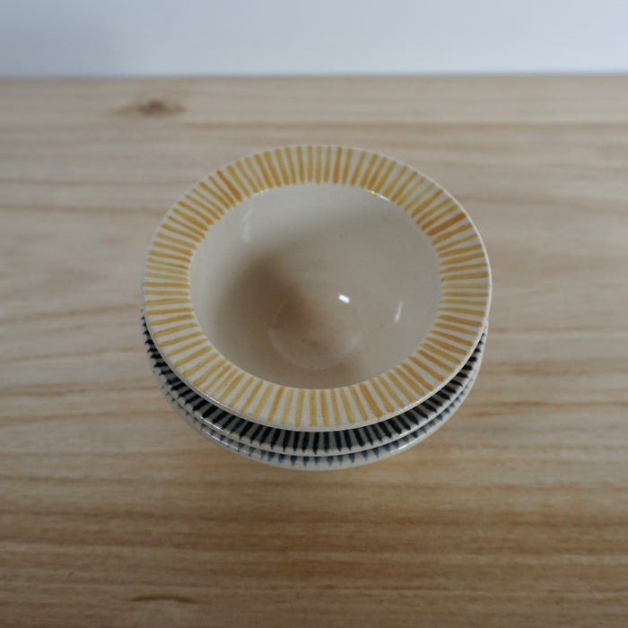 yellow stripped handmade ceramic snack bowl. 