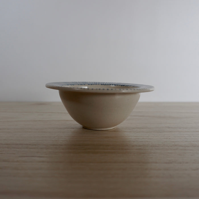 side view of a hand thrown snack bowl. 