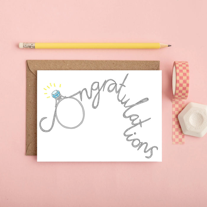 hand drawn engagement card with the word congratulations and the C is a diamond ring. 