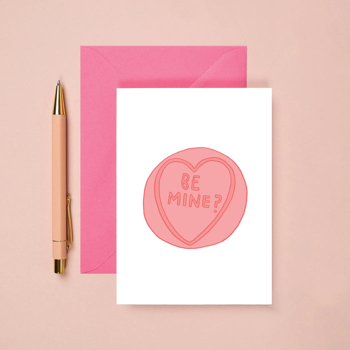 card with a love heart sweet that says be mine. 