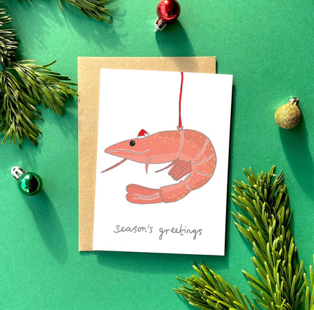 Christmas card with a hanging prawn ornament. 