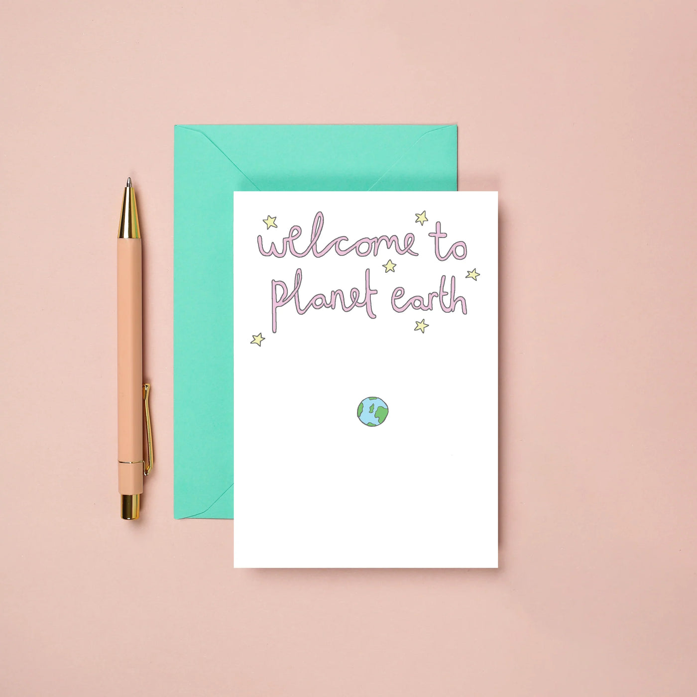 greetings card with a drawing of the earth and it reads "welcome to planet earth" 