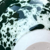 close up of a green splatter glaze by anna jones ceramics. 