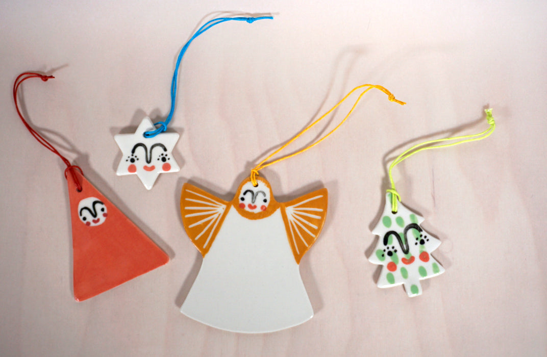 four christmas decorations handmade ceramics by Beci Callow. an angel, a santa, a star and a christmas tree. 