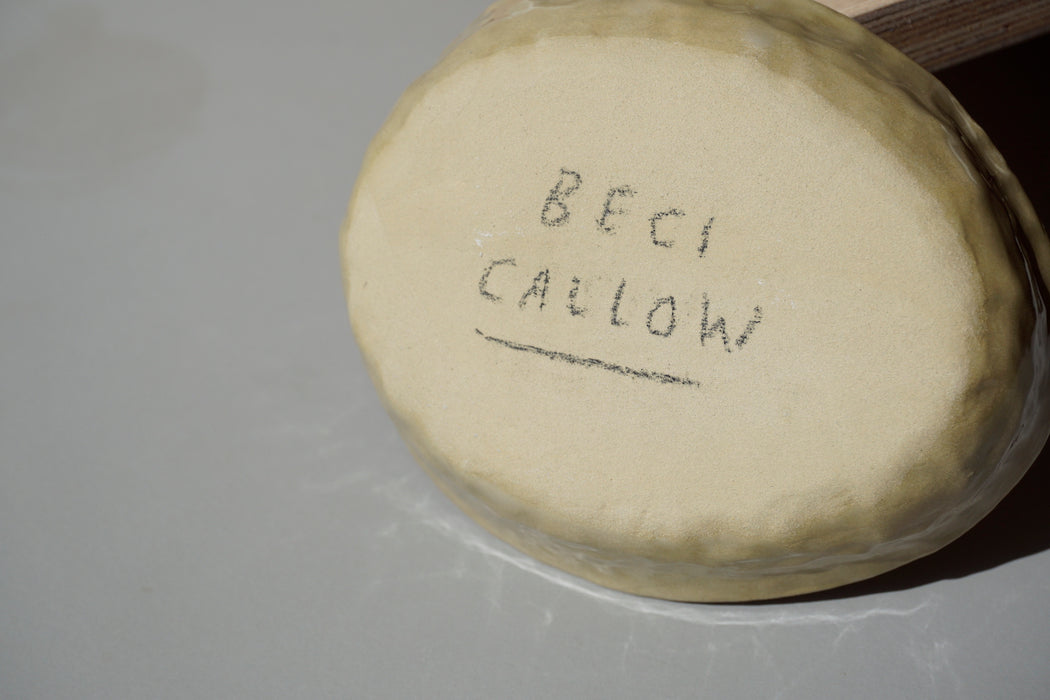 Beci Callow's signature on the bottom of a green soap dish. 