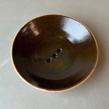 a glossy rich tobacco soap dish on a light grey background. 