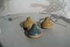 three Cara Guthrie bud vases sitting on a table. 